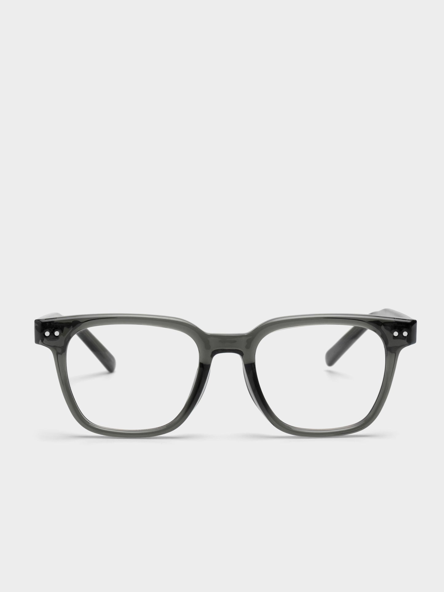 Dark green eyeglasses on a light gray background