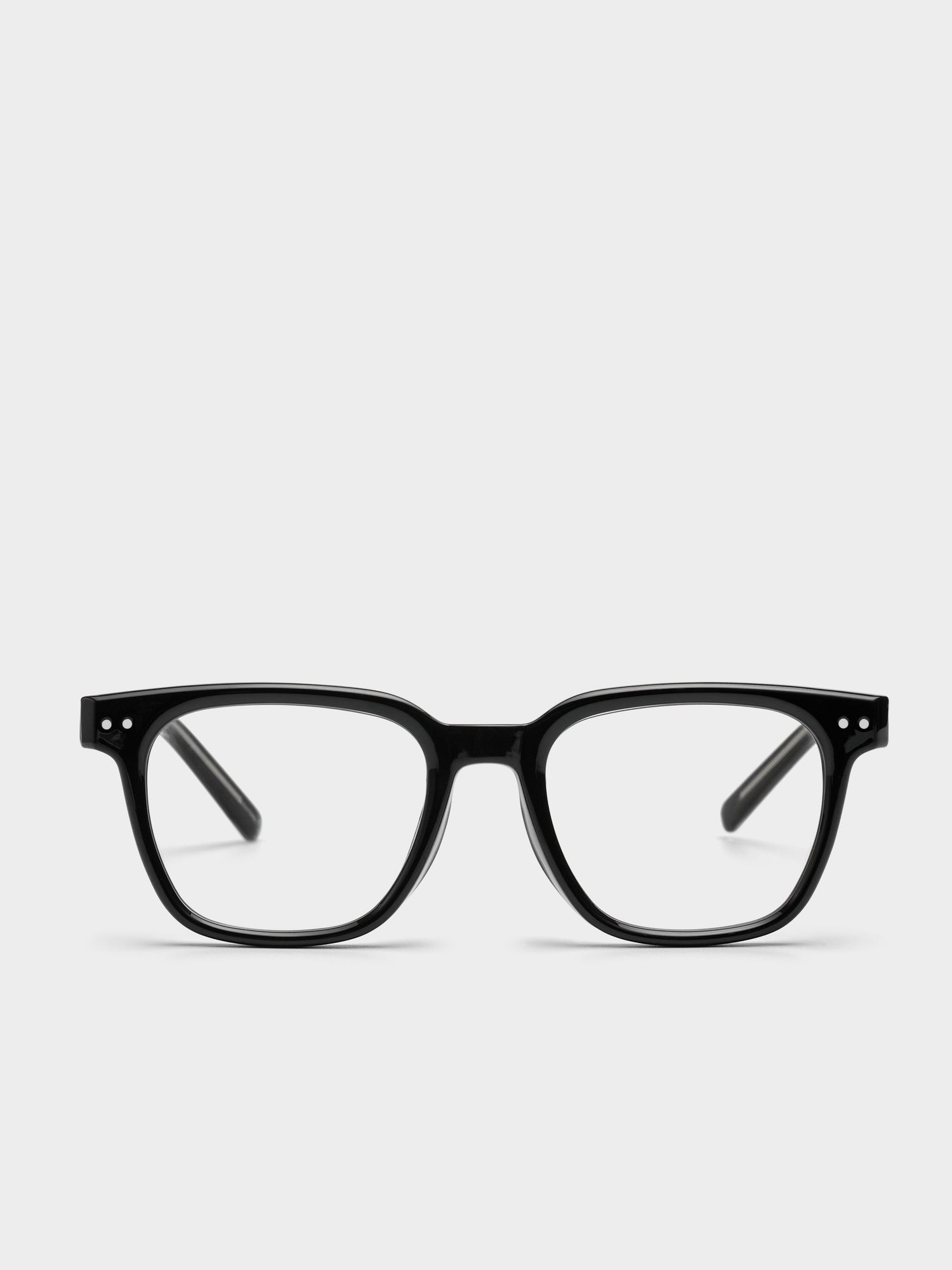 Black rectangular eyeglasses on a light gray background